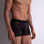 Model wearing 'Fleurs Magiques' Boxer Shorts by Aubade (side front view).