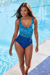 Model by pool wearing 'It's A Wrap' Swimsuit in Blue Multi from Miraclesuit's Alhambra collection.