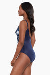Model wearing 'Oceanus' Swimsuit in Midnight Blue & White, from the Tropica Toile collection by Miraclesuit (side view).