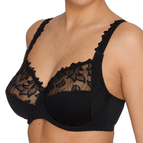 Black full cup bra by PrimaDonna, in the Deauville collection. The shot of the model's chest is sideways-on and against a white background.