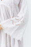 Model wearing 'Sebena' White Short Kaftan, by Melissa Odabash (sleeve detail).