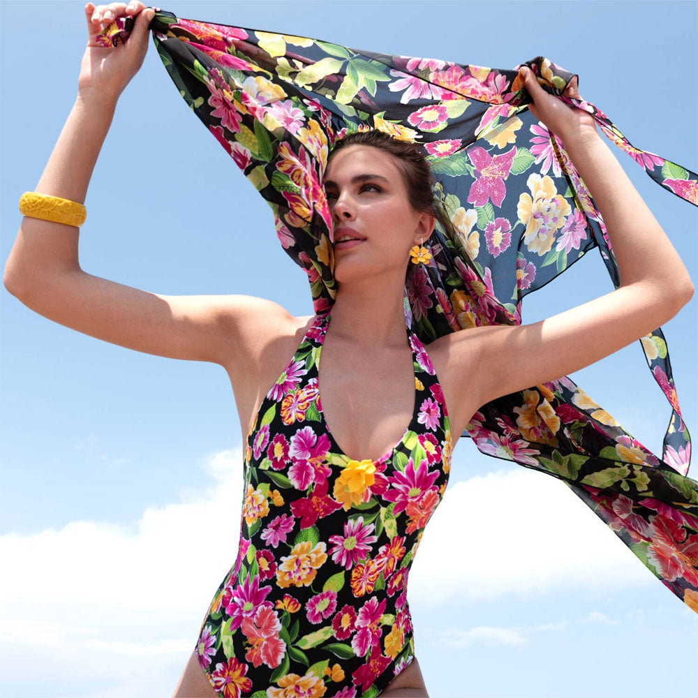 Model wearing 'La Feminissima' Non-Wired Halterneck Swimsuit in Rose Améthyste (Floral on Black), by Antigel.