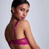 Model wearing 'Danse des Sens' bra in dark fuchsia, by Aubade (rear/side view).