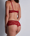 Model wearing 'Danse des Sens' Cheeky Brief in Irresistible Red, by Aubade.