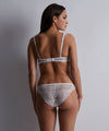 Model wearing 'Danse des Sens' Opal White Half Cup Bra, by Aubade (back view).