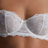 Model wearing 'Danse des Sens' Opal White Half Cup Bra, by Aubade (detail).