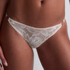 Model wearing 'Flawless Love' Pinkish Beige Mini-Coeur Brief, by Aubade (front view, close up).
