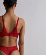 Model wearing Aubade 'Rosessence' Red Comfort Moulded Half Cup Bra (back view).