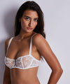 Model wearing 'Kiss of Love' White Half Cup Bra, by Aubade.