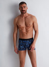 Model wearing 'Fleur Bleue' Blue Boxer Short, by Aubade (front view).