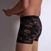 Model wearing 'Blurred Flowers' Boxer Shorts by Aubade (side view).