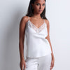 Model wearing 'Midnight Whisper' Opal White Camisole, by Aubade (front view).