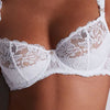 Model wearing 'Mon Bijou' White Half Cup Bra, by Aubade (detail).