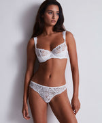 Model wearing 'Mon Bijou' White Half Cup Bra, by Aubade.