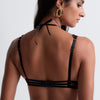 Model wearing 'Night at Paradise' Black Push-Up Plunge Bra, by Aubade (back view, close up).