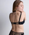 Plus size model wearing 'Night at Paradise' Black Push-Up Plunge Bra, by Aubade (back view).