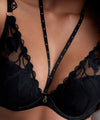 Model wearing 'Night at Paradise' Black Push-Up Plunge Bra, by Aubade (front view, close up).