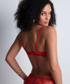 Model wearing 'Rules of Attraction' Red Underwired Half Cup Bra, by Aubade (back view).