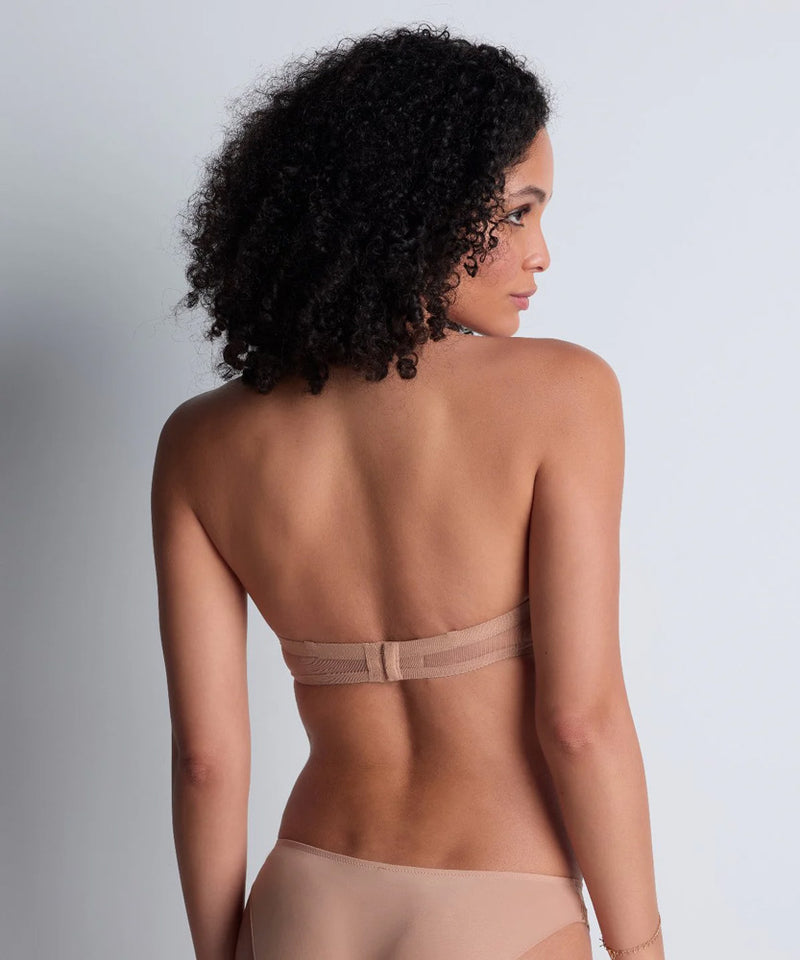 Model wearing 'Sheer Emotion' Sand Moulded Strapless Bra, by Aubade (back view).