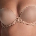 Model wearing 'Sheer Emotion' Sand Moulded Strapless Bra, by Aubade (front view, detail).