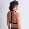 Model wearing 'Summer Stars' Black Halterneck Bikini Set, by Aubade Swim (back view).