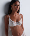 Model wearing 'Vibes' Pearl White Shoulder Full Cup Bra, by Aubade (front view).