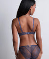 Model wearing 'Vibes' Denim Blue Italian Brief, by Aubade (back view).
