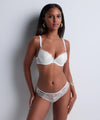 Model wearing 'Vibes' White Italian Brief, by Aubade (front view).