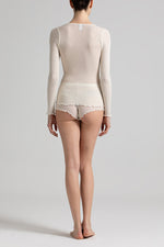 Model wearing 'Basilia' Cream Long-Sleeved Tank Topny Boglietti (back view).