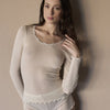 Model wearing 'Basilia' Cream Long-Sleeved Tank Topny Boglietti (front view, close up).