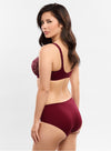 Model wearing Empreinte 'Agathe' (Burgundy) Low-Necked Bra, by Amarante (side view).