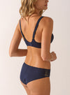 Model wearing 'Agathe' Cobalt (Navy Blue) Low-Necked Bra, by Empreinte (back view).