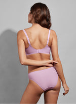 Model wearing Empreinte 'Romy' Lilac Low-Necked Half Cup Bra (back view).