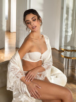 Model wearing 'Bellissime Amour' Ivory Silk Thong, by Lise Charmel (side/front view).