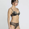 Model wearing 'Deesse en Glam' Contour Bra in black and gold by Lise Charmel (side view).