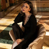 Model wearing 'Deesse en Glam' Long-Sleeved Top in black and gold by Lise Charmel