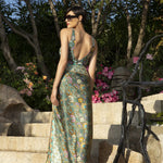 Model in lush Mediterranean garden wearing Lise Charmel Fleur Persane multicolour swimsuit and pareo.