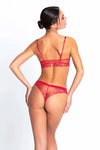 Model wearing 'Source Beauté' Thong in Hibiscus Beauté (Coral), by Lise Charmel.