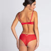 Model wearing 'Splendeur Soie' Shorty Brief in Rouge (red), by Lise Charmel (back view).