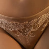 Model wearing 'Splendeur Soie' Nude/Dusky Pink Thong, by Lise Charmel (detail).