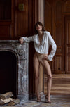 Model wearing 'Valeria' Ivory Silk Bodysuit, by Marjolaine (front view).