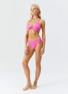 Model wearing 'Brussels' Watermelon Pink Halterneck Bikini Set, by Melissa Odabash (side view).