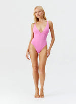 Model wearing 'Caribbean' Pink Plunge Swimsuit, by Melissa Odabash (front view).