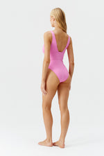 Model wearing 'Caribbean' Pink Plunge Swimsuit, by Melissa Odabash (back view).