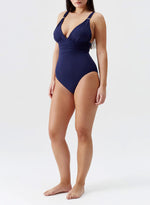 Model wearing 'Panarea' Navy Swimsuit, by Melissa Odabash (side view).