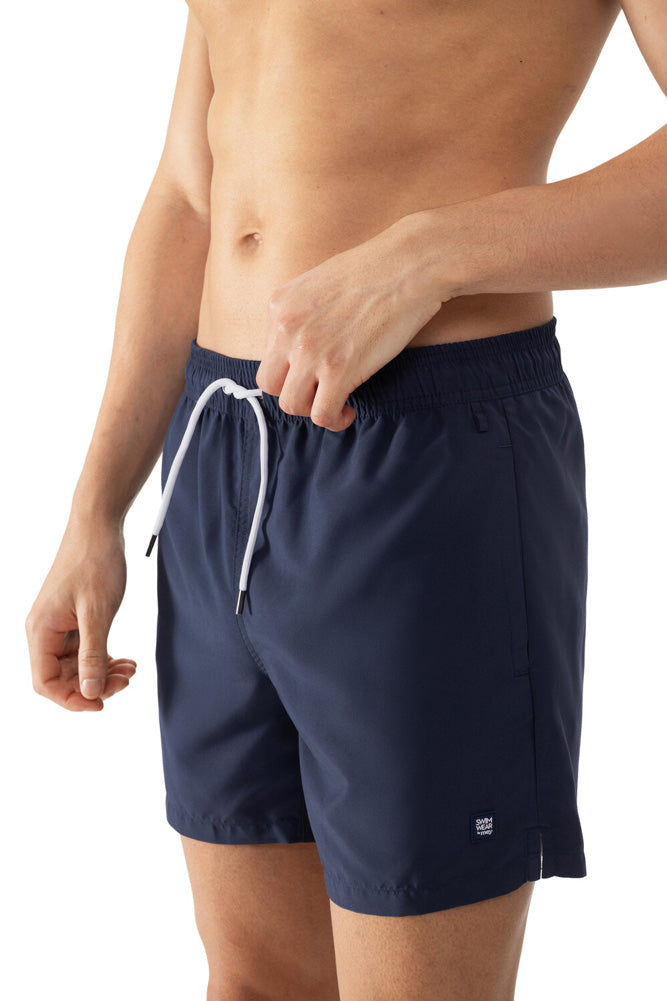 Model wearing 'Darley' Navy Blue Men's Swimming Shorts, by Mey (front view, close up).