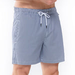 Model wearing 'Beachport' Blue Pinstripe Men's Swimming Shorts, by Mey (front view, close up).