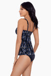 Model wearing 'Ayla' Tankini in Black/Multi from Miraclesuit's Bronze Reign collection.