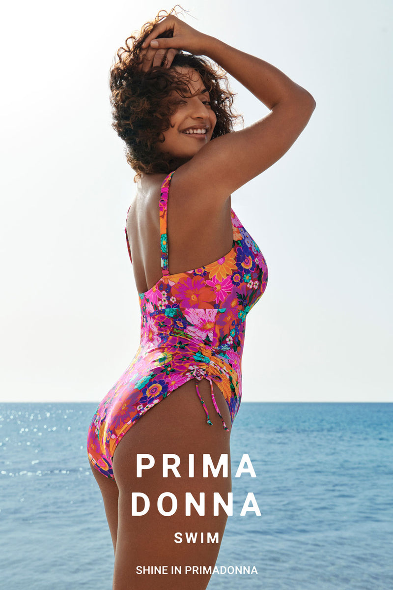 PrimaDonna promo poster showing model wearing 'Najac' Plunge Swimsuit (Multicolour).