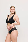 Model wearing 'Rupi' Black Half Padded Plunge Bra, by PrimaDonna Twist (side view).